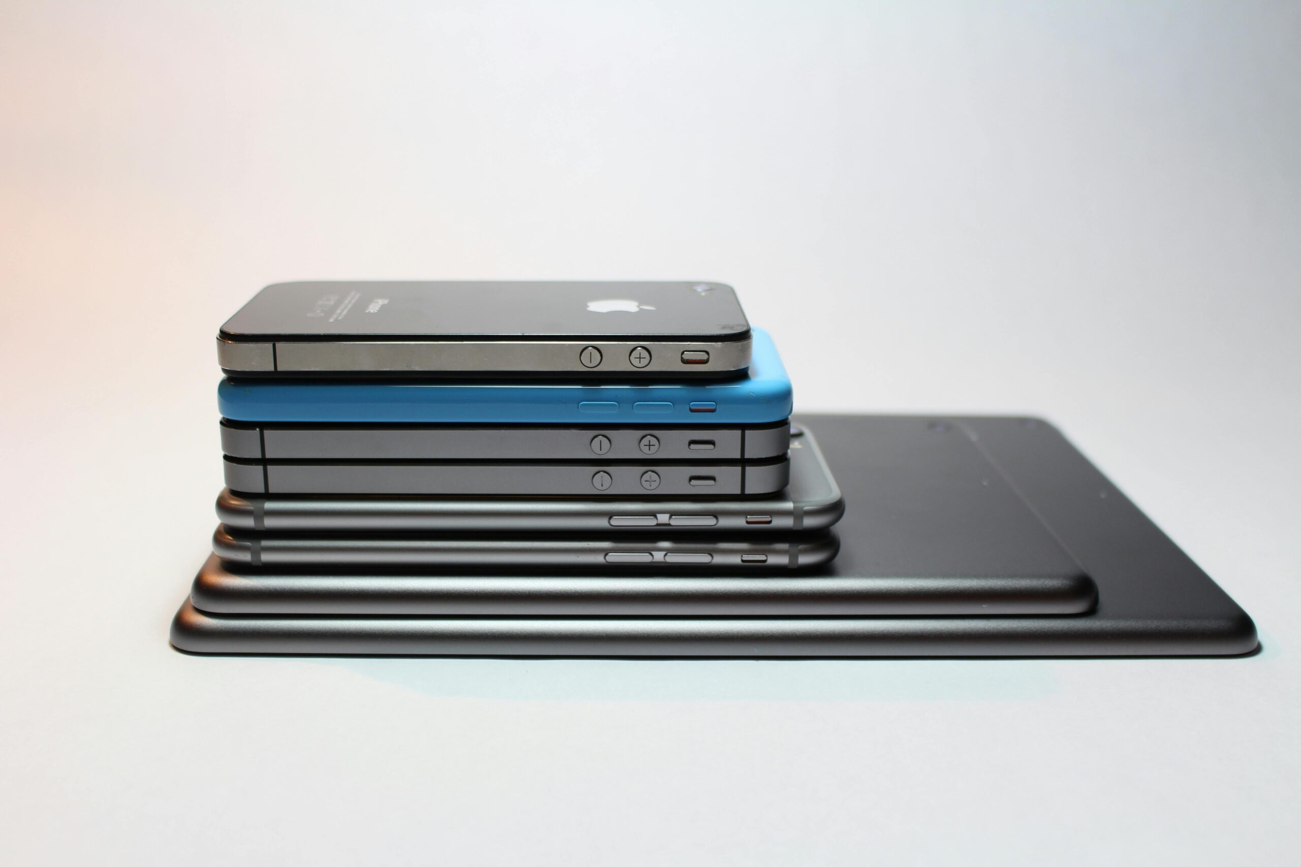 Stacked modern smartphones and tablets showcasing sleek design. Perfect tech background.